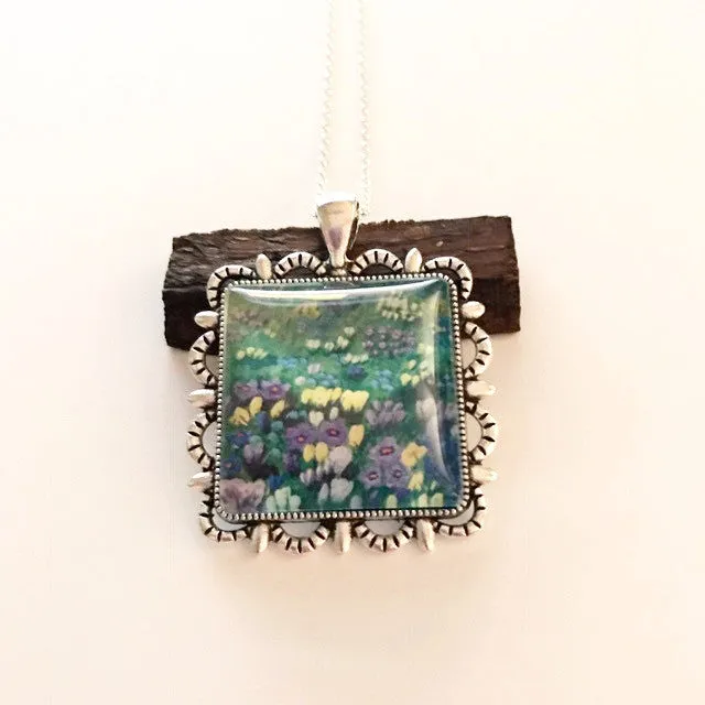 Watercolor on a pendant/field of flowers on a blanket of green